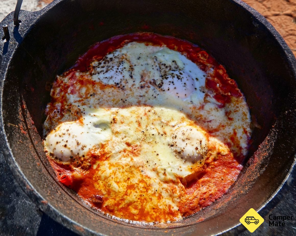 Baked eggs cooking in a camp overn