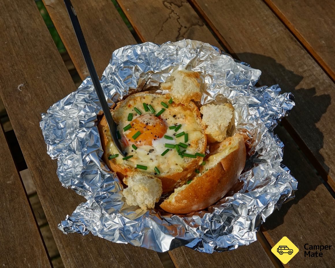 Mini cob loaf cooked in foil with a campfire